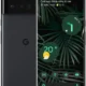 Foldable Android phone on a tropical plant wallpaper, showing weather and app shortcuts on the home screen.