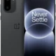 Front and back view of a dark gray OnePlus smartphone with a dual-camera module and 'Never Settle' on the screen surface.